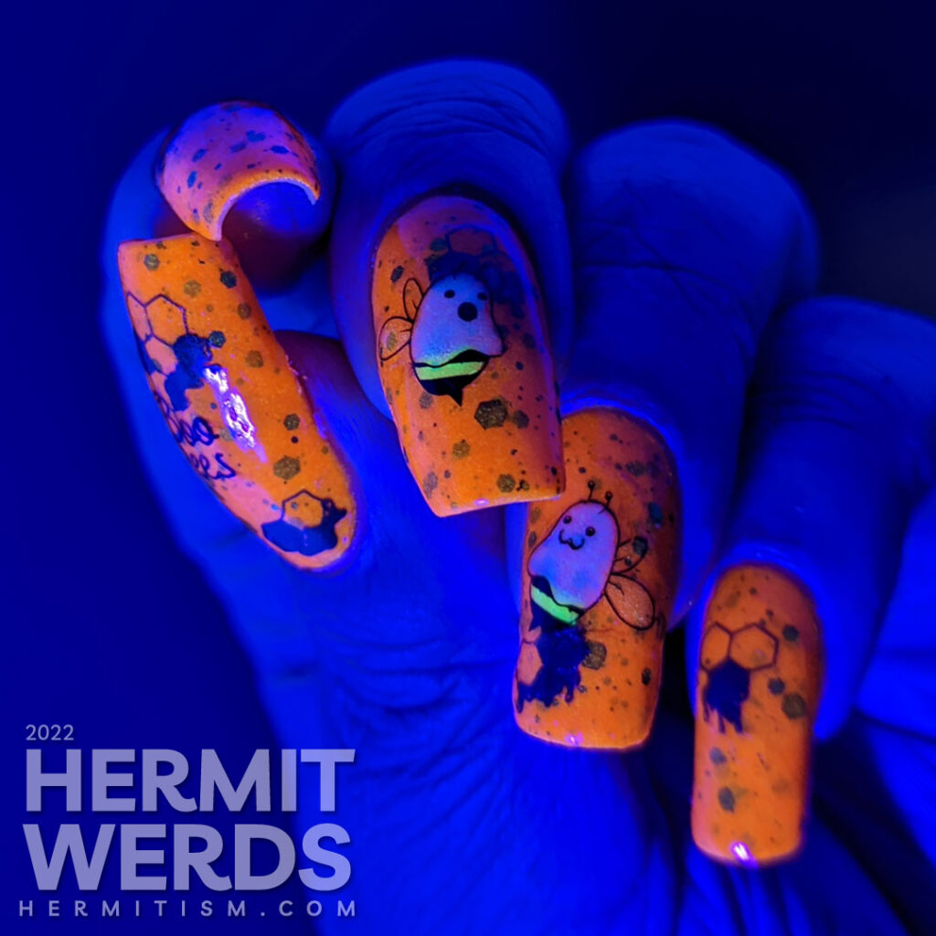 A punny bee nail art with stamping decals of ghost bees (boo bees) on a bright orange crelly with green glitter that glows orange in the dark.