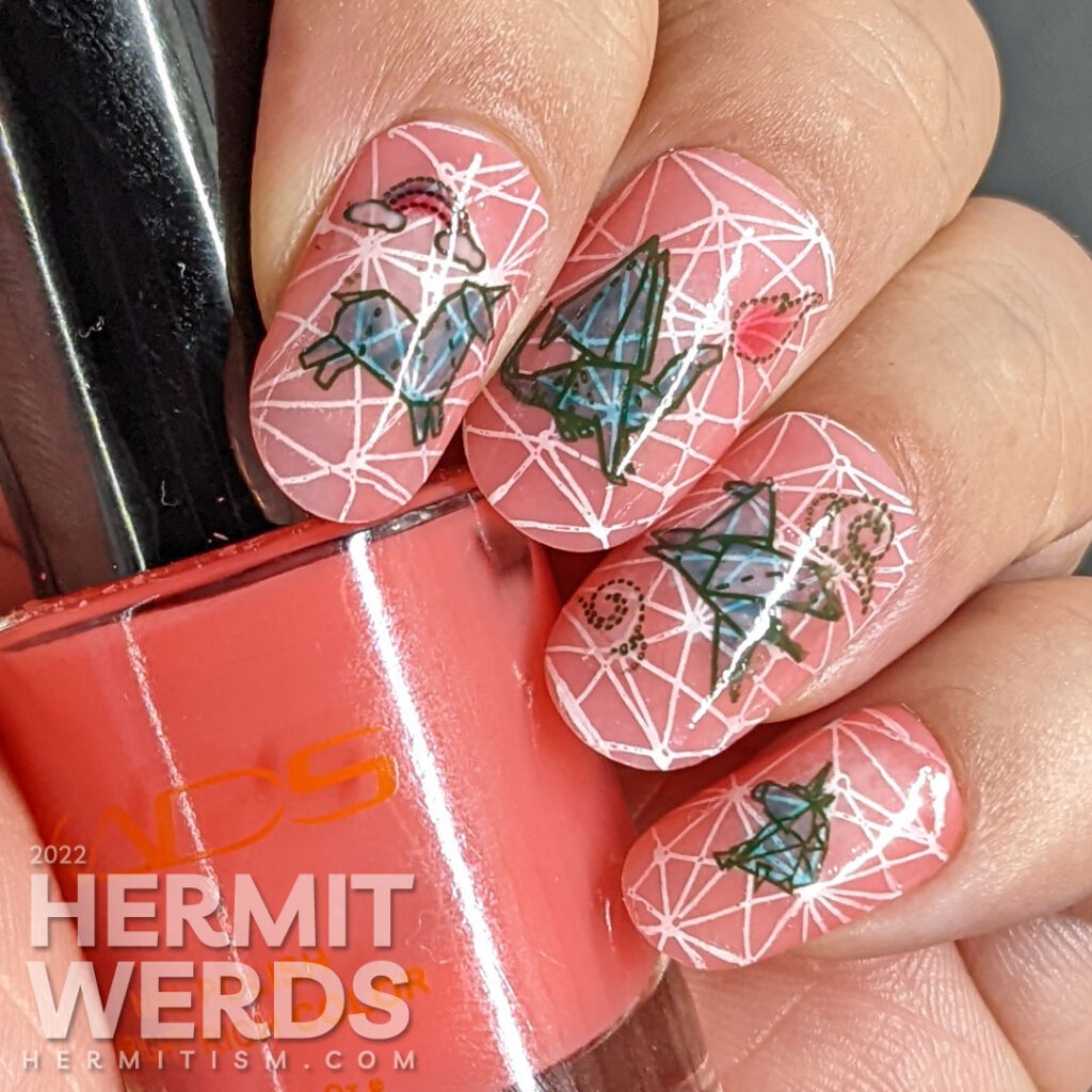 Mythical nail art with teal origami stamping decals of dragons, unicorns, and Pegasus on top of a jelly coral base and pond geometric pattern.