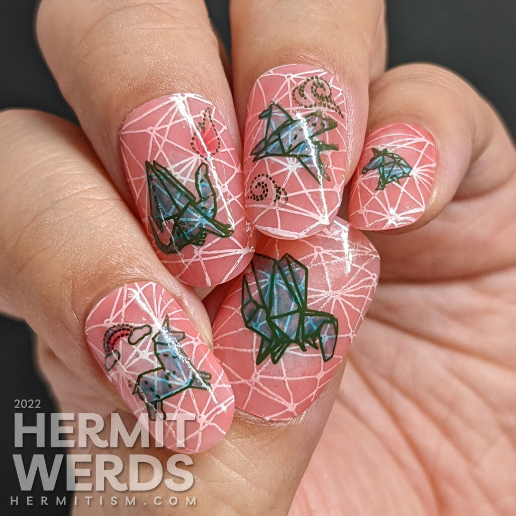 Mythical nail art with teal origami stamping decals of dragons, unicorns, and Pegasus on top of a jelly coral base and pond geometric pattern.