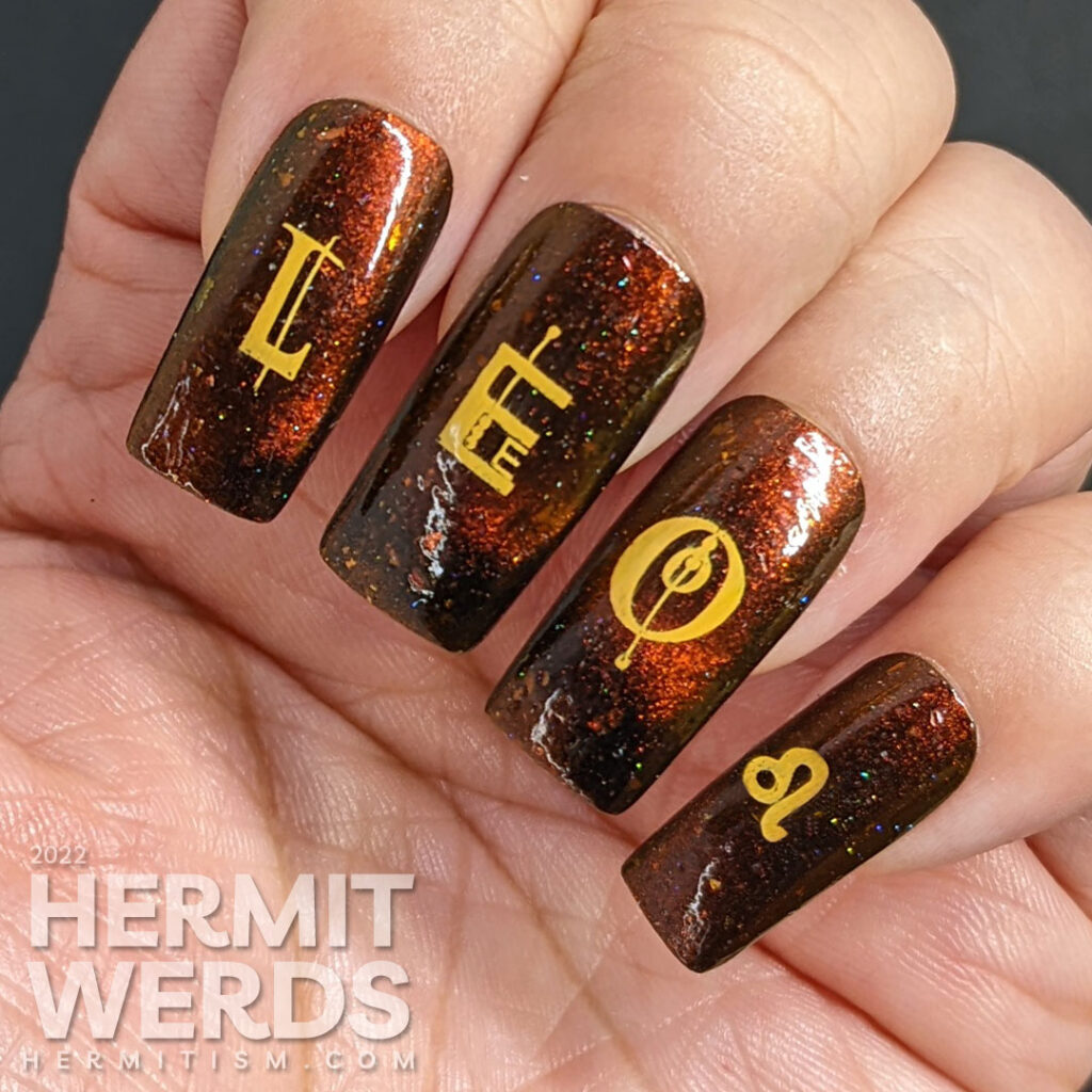 A fiery magnetic nail art for the zodiac sign Leo; stamping decals include a geometric letters spell "Leo", a Leo symbol + a lion-like lady.