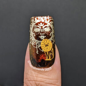 A Leo nail fail with a boho sun stamped behind a lion decal on a fiery magnetic base.