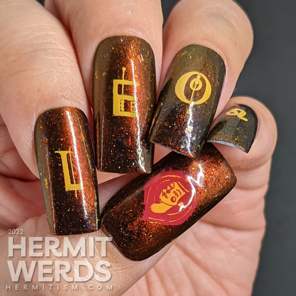 A fiery magnetic nail art for the zodiac sign Leo; stamping decals include a geometric letters spell "Leo", a Leo symbol + a lion-like lady.