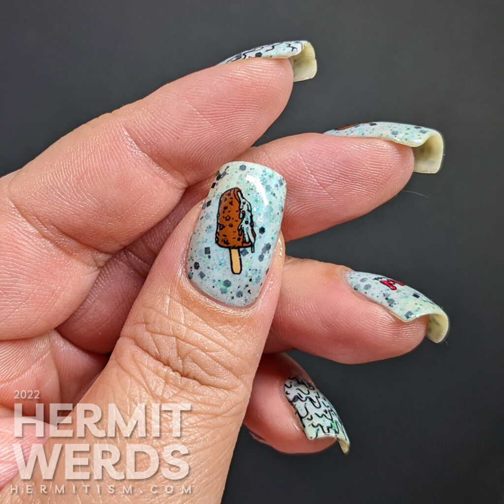 Summer nail art with melting popsicles and ice cream stamping decals on top of a crelly that resembles chocolate mint ice cream.