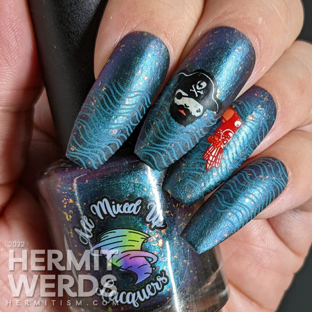 Talk Like a Pirate Day nail art with cute pirate stamping images (captain, ship, parrot) on a teal to purple multichrome polish.Talk Like a Pirate Day nail art with cute pirate stamping images (captain, ship, parrot) on a teal to purple multichrome polish.