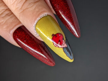 A deep red and prugly green stiletto mani with the Disney-esque evil queen from Snow White and her poison apple. Eat me!