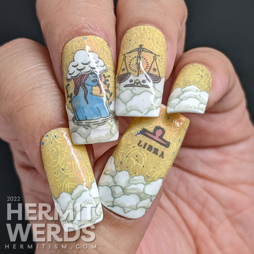 Libra nail art with a yellow sky and stamping decals of abstract faces, a lady with her head in the clouds, more clouds, and Libra scales.