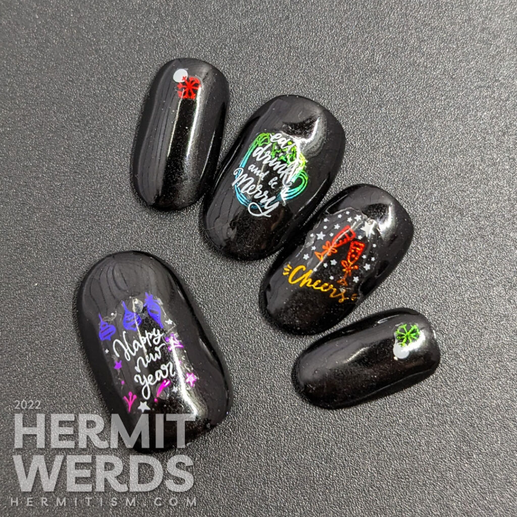 A glossy black holiday season nail art with shiny rainbow nail stickers with white accents offering cheers to a New Year.