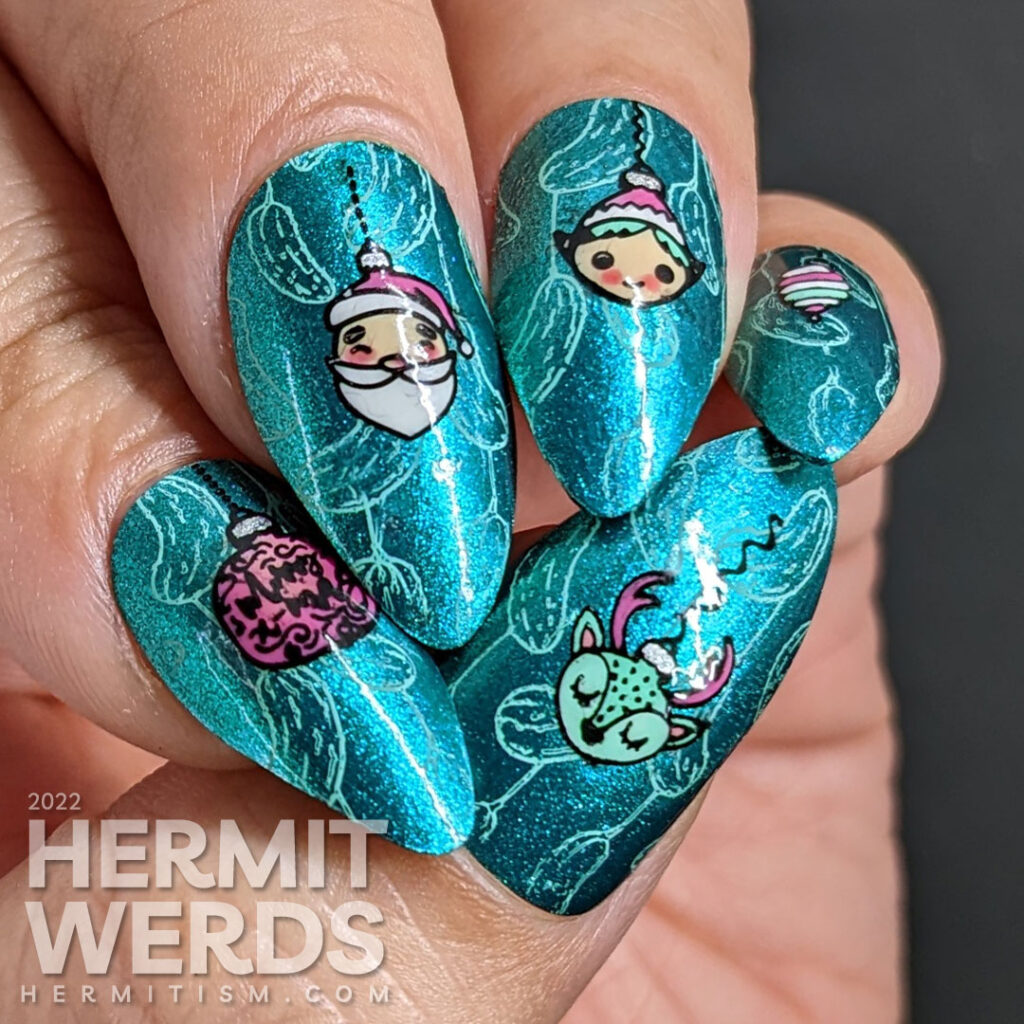 Glitzy teal Christmas ornament nail art with Christmas pickles stamped in the background and Santa, reindeer, elf stamping decal ornaments.