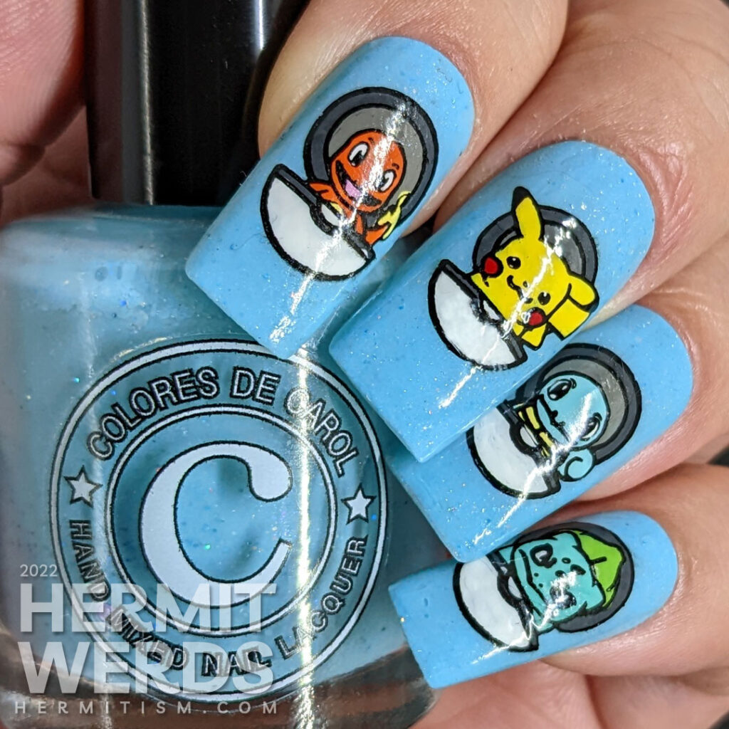 Pokémon nail art with open pokeballs containing Charizard, Pikachu, Squirtle, and Bulbasaur and trainer Ash Ketchum himself on the thumb.