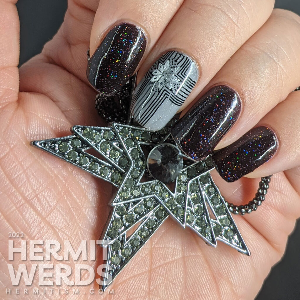 A grey, black, and silver glitzy gift mani for Christmas with double stamped giant bows and ribbons and holographic glitter sparkling away.