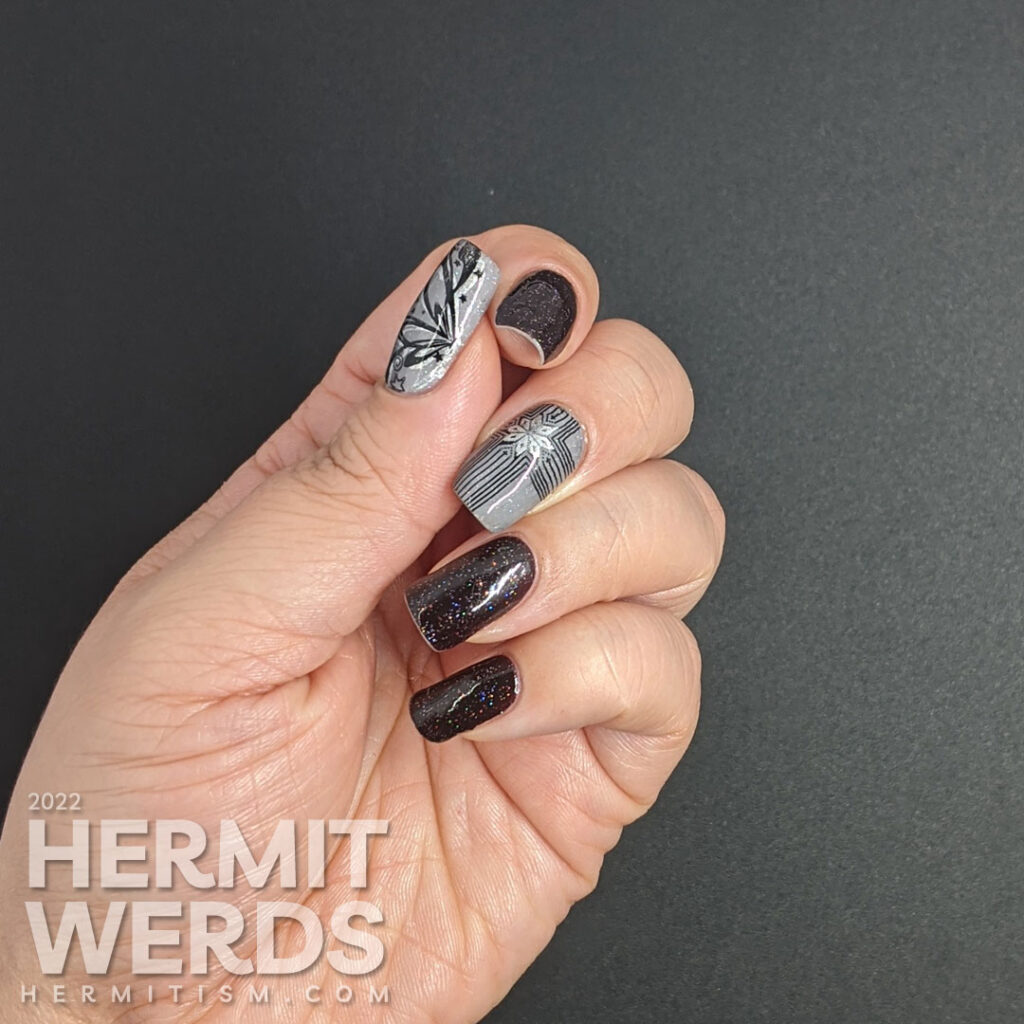 A grey, black, and silver glitzy gift mani for Christmas with double stamped giant bows and ribbons and holographic glitter sparkling away.