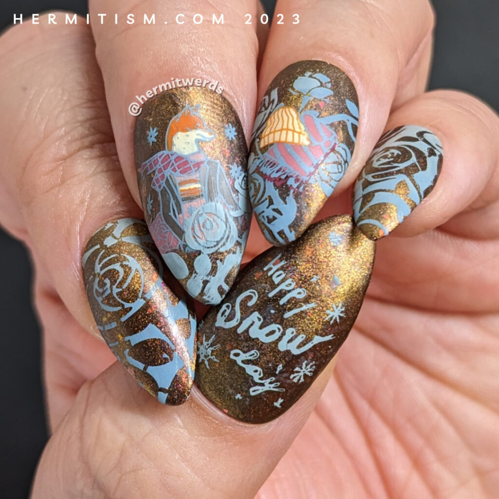 A cozy, matte scarf-wrapped fox nail art with more stamping decals of winter gear, roses, and snowflakes on a copper magnetic base.