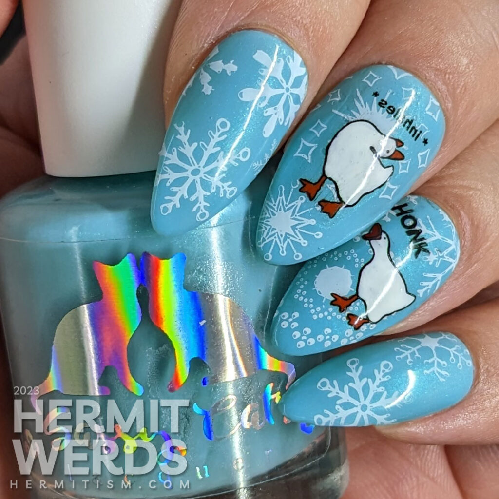 Cool blue goose nail art featuring the Untitled Goose Game's naughty goose and honking on a backdrop of snowflakes. Threat level high.