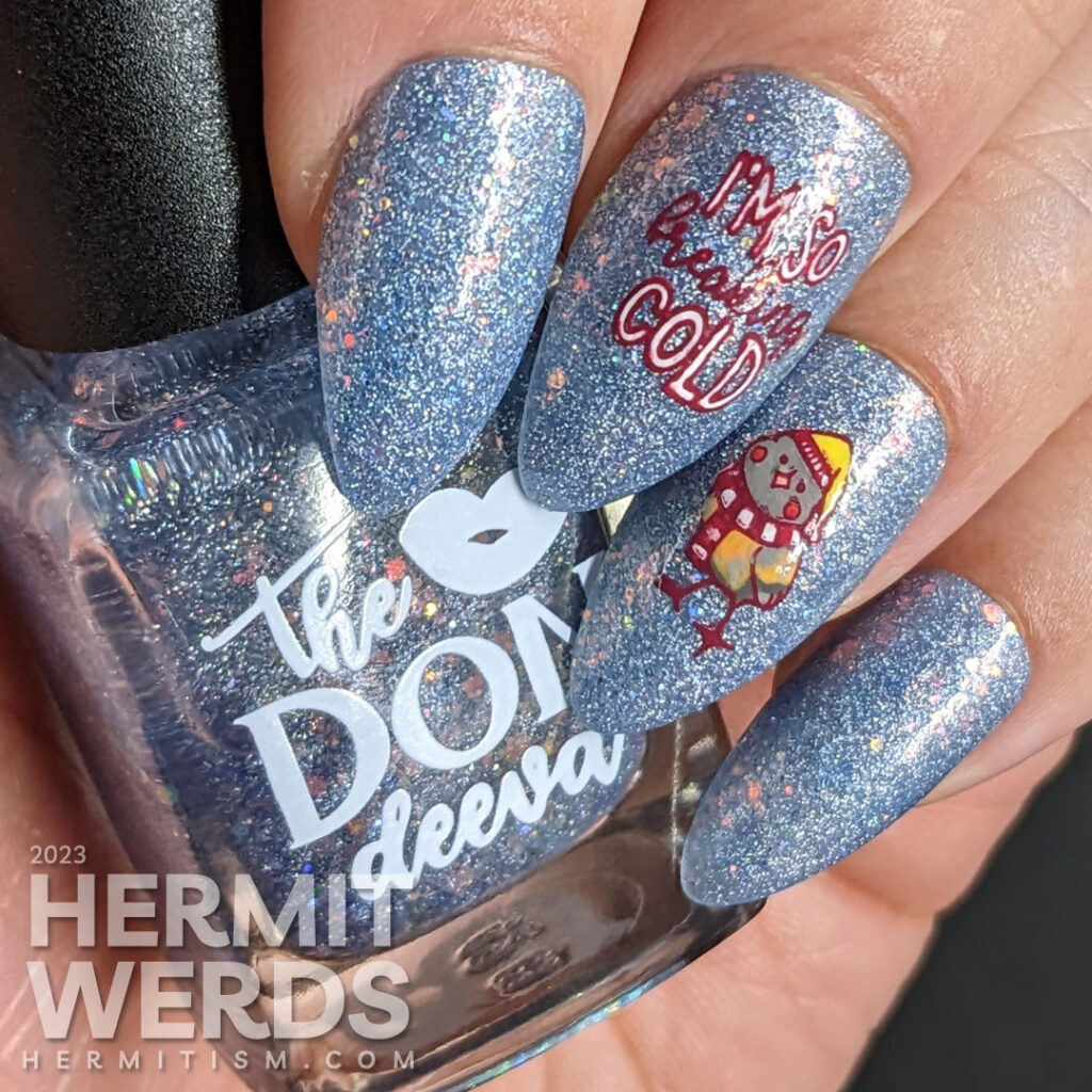 Cute little winter bird nail art with stamping decals of birds in hats and scarves on an extra glitzy blue nail polish