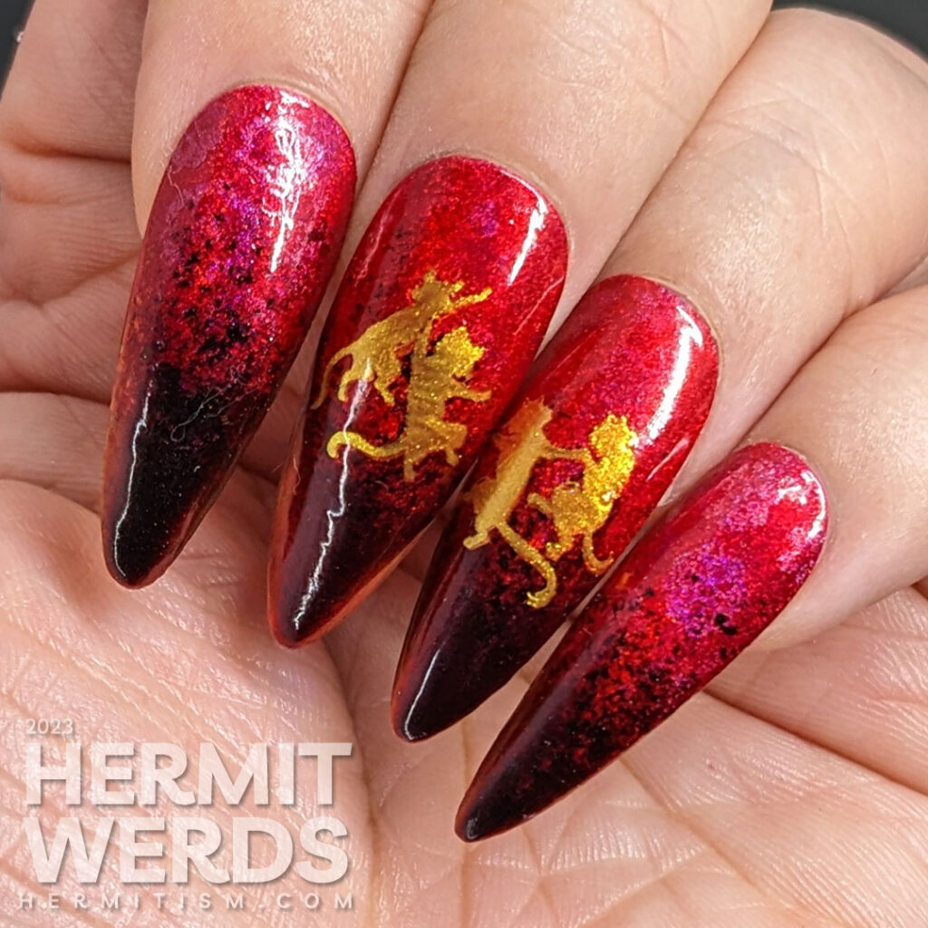 A Lunar New Year nail art for the Year of the Cat, which is the zodiac animal for the Vietnamese in red, black, and gold w/dancing cats.