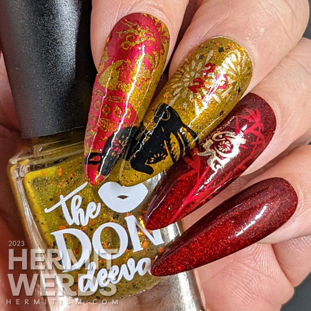 Chinese New Year nail art for the Year of the Rabbit with holographic red, deep mustard, gold, and black polish + rabbit cutouts and bamboo.