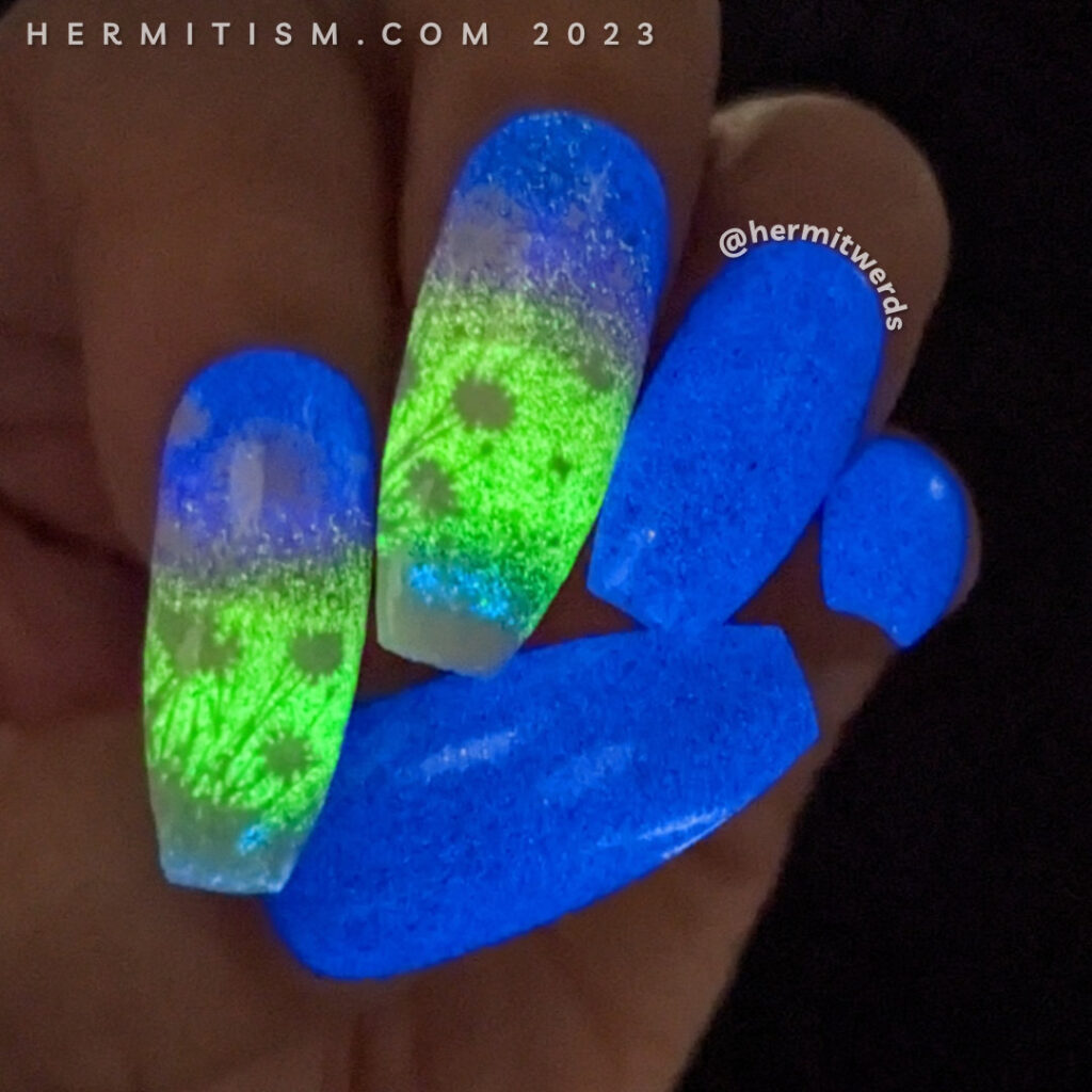 An alternate glow in the dark sunset nail art with dandelion silhouettes stamped on top. Sunset: purple to pink to orange to yellow to green.