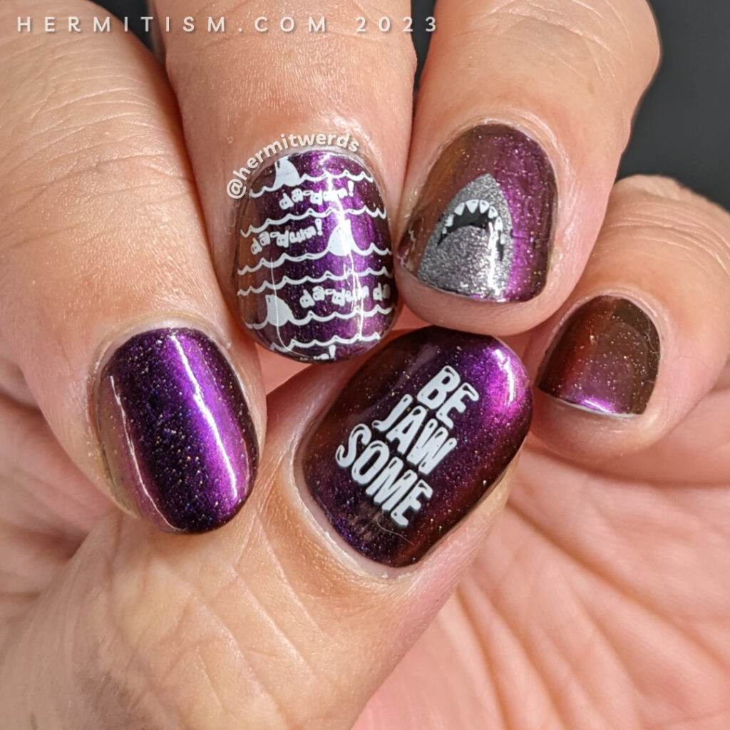 Shark nail art on a dark purple to pink to orange to green ultrachrome with Jaws da-dum shark nail stamping. Jaws movie nails for Shark Week.