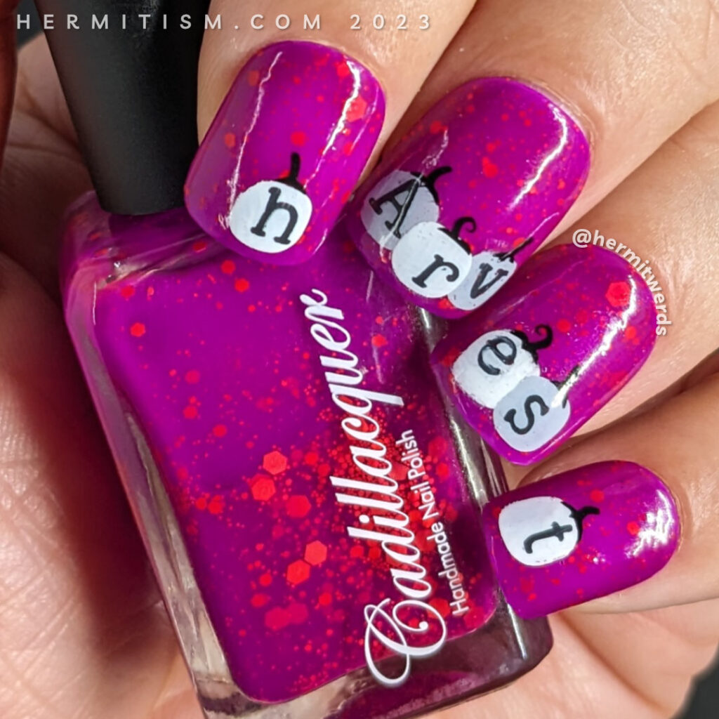 Pumpkin nail art with black and white pumpkins spelling "harvest" against a bright fuchsia nail polish w/orange glitter and a Halloween cat.