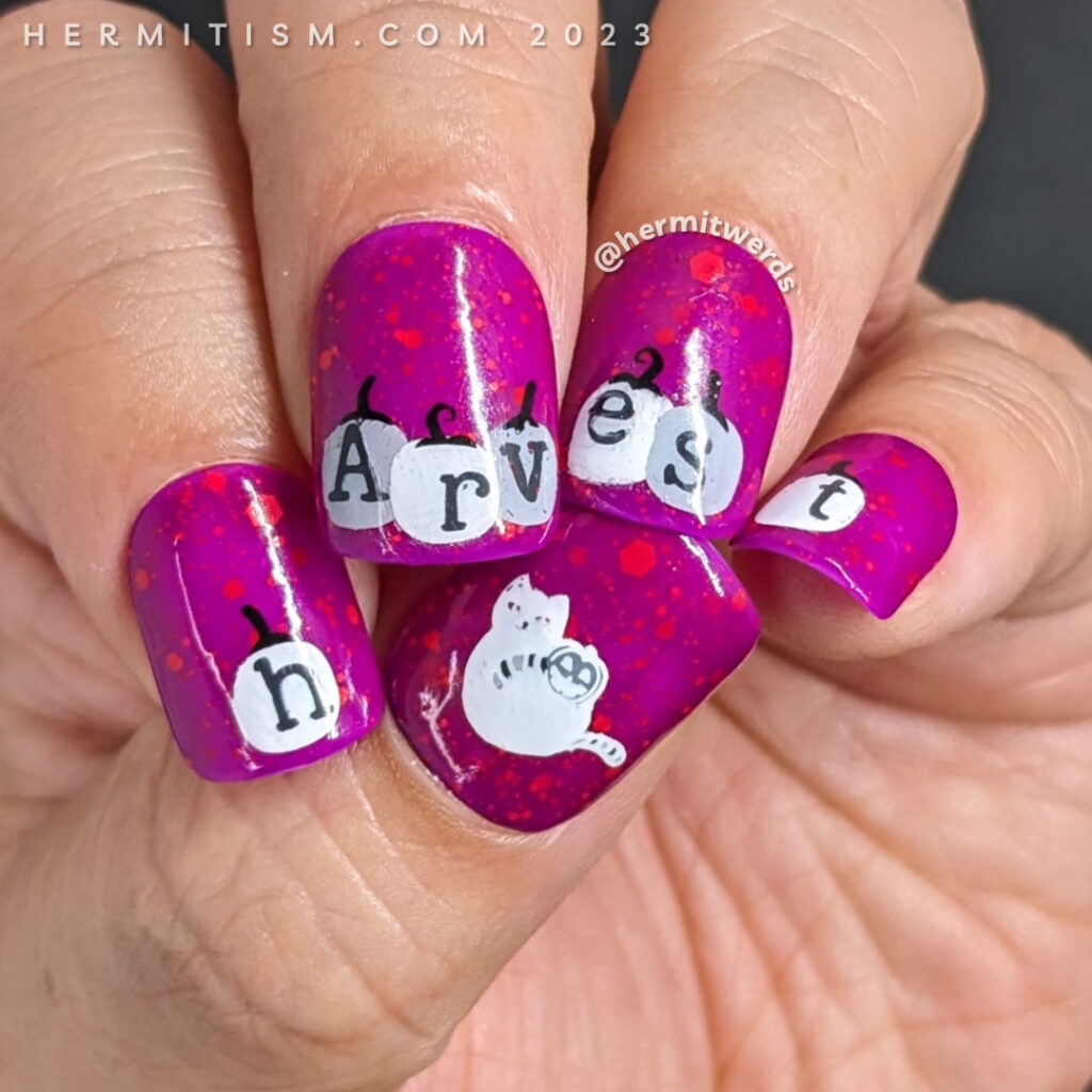 Pumpkin nail art with black and white pumpkins spelling "harvest" against a bright fuchsia nail polish w/orange glitter and a Halloween cat.