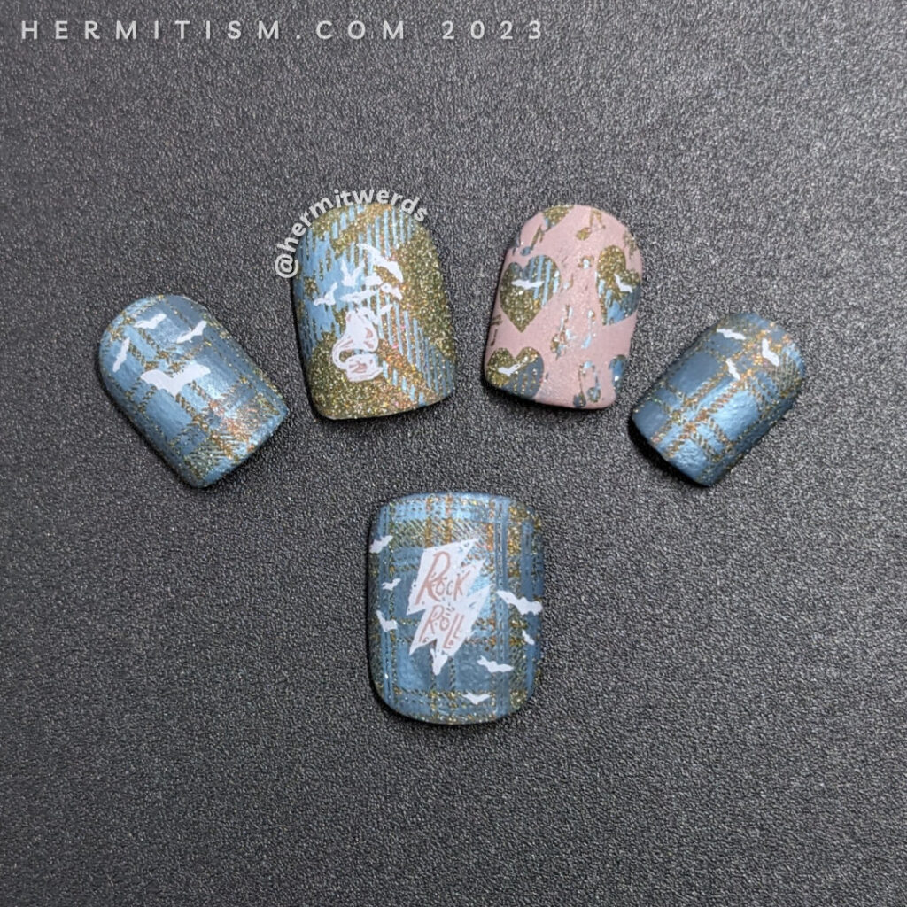A batty nail art with a background of blue plaid stamped over olive reflective glitter and music and bat stamping decals.