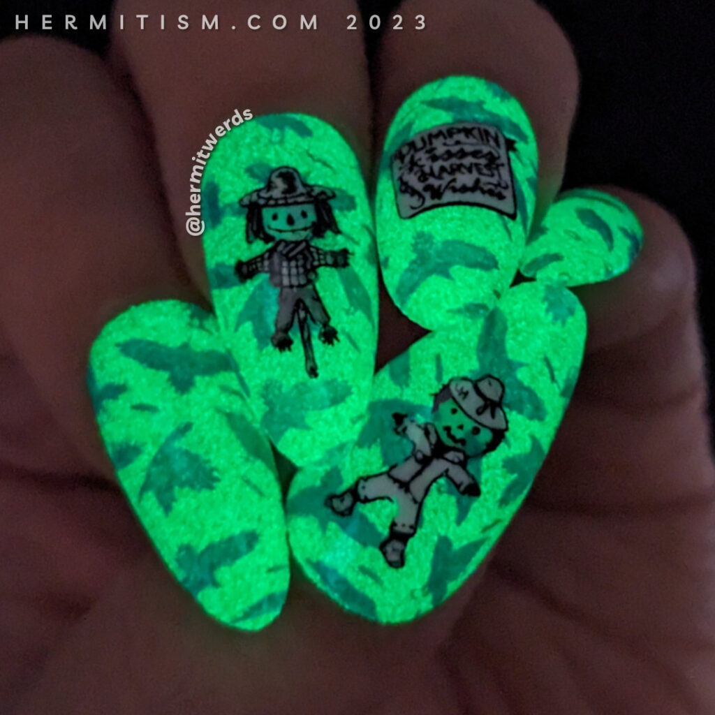 Scarecrow nail art with a bright blue & green background of flapping crows with cute black and white scarecrows stamped on top.