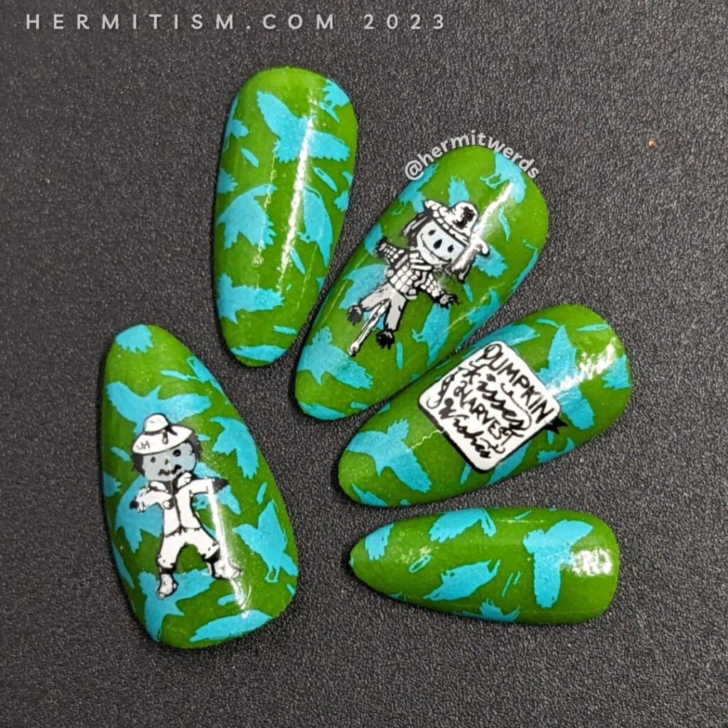 Scarecrow nail art with a bright blue & green background of flapping crows with cute black and white scarecrows stamped on top.