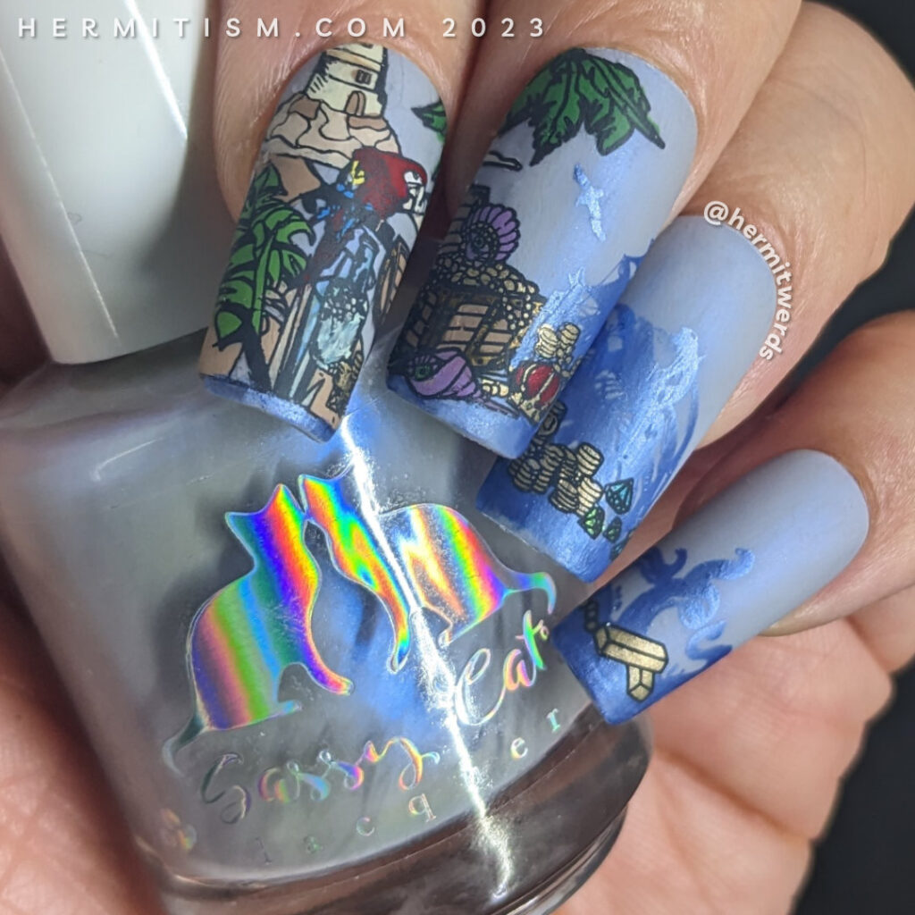 Pirate nail art with tons of pirate details (parrots, treasure chest, gold island, maps, pirate hat, pirate ship, lighthouse, kraken, etc).