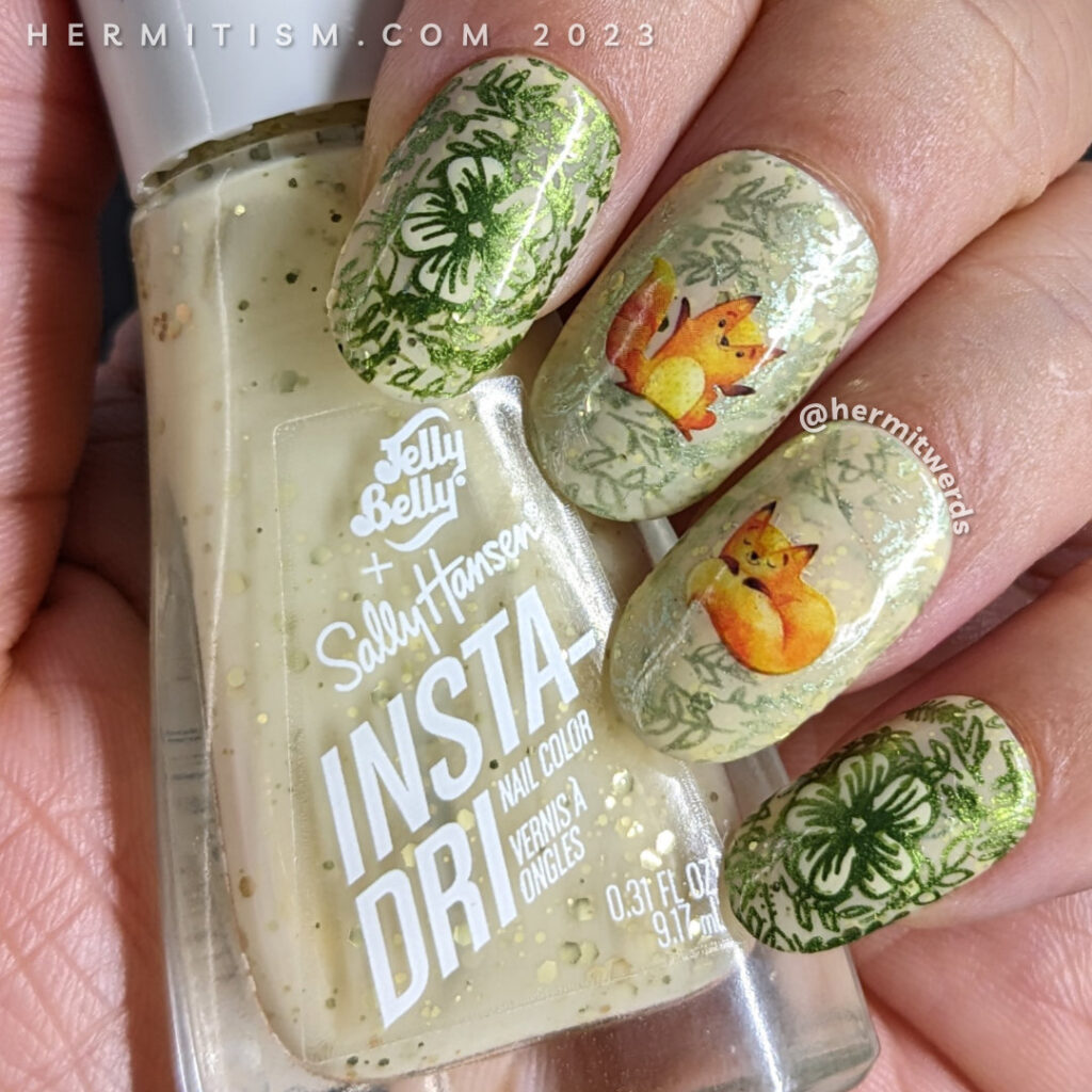 A sweet fox nail art using watercolor-esque fox water decals on top of a pale yellow crelly base with metallic floral prints stamped on top.