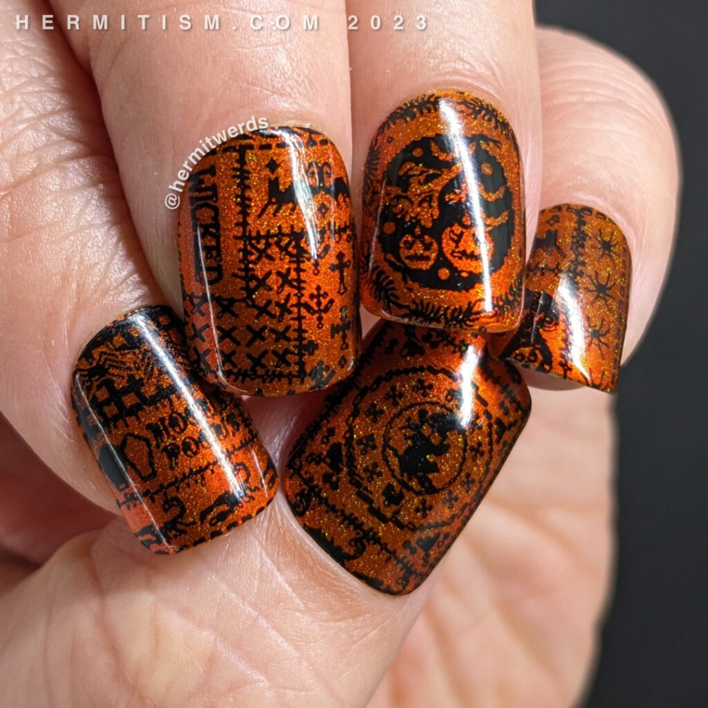 A simple orange magnetic Halloween quilt nail art with cozy quilt patterns of everything from pumpkins to black cats to spiders in black.