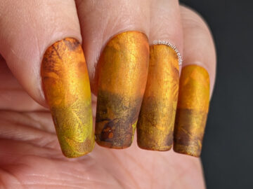 A golden, orange, and brown magnetic mani of fall leaves gently blending into each other for a soft, abstract look. + one bastard stink bug.