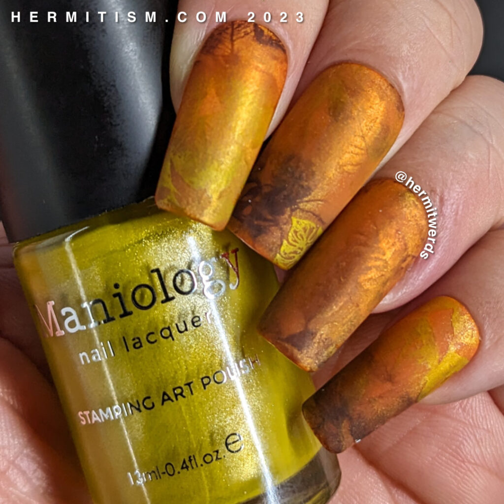 A golden, orange, and brown magnetic mani of fall leaves gently blending into each other for a soft, abstract look. + one bastard stink bug.