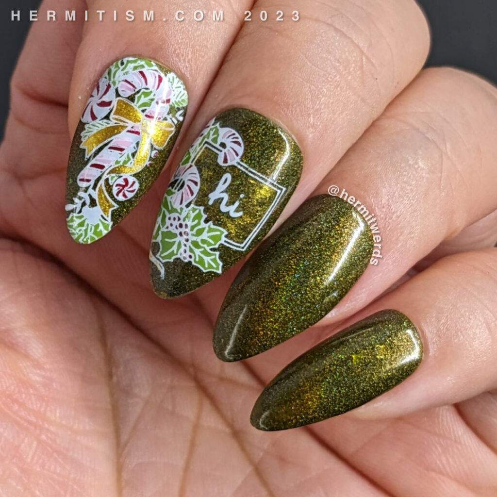 A sweet candy cane nail art for the Christmas season with peppermint candy canes and holly on a dark olive green holographic polish.