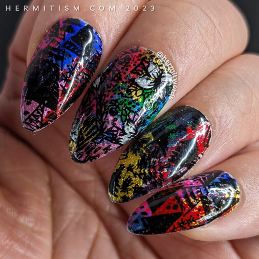 A brightly tacky holiday nail art with a rainbow of holographic nail foils and black holiday patterns with trees and flowers stamped on top.