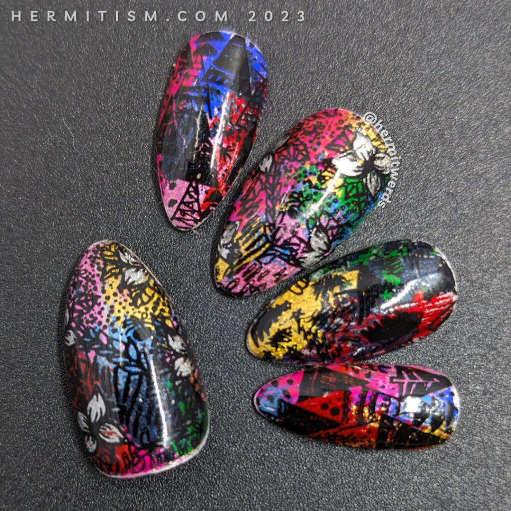 A brightly tacky holiday nail art with a rainbow of holographic nail foils and black holiday patterns with trees and flowers stamped on top.