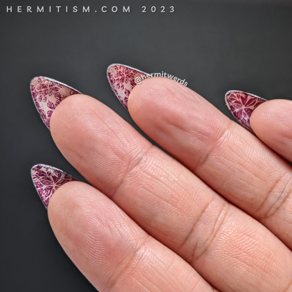 Flipside poinsettia nails with a snazzy poinsettia stamping image against a silver (chrome) background.