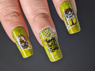 Monstrous family portrait nail art with a sweet green wallpaper background and reverse stamping decals of framed monster strewn with cobwebs.