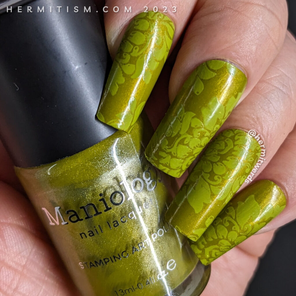 Beautiful brocade nail art with a shimmery olive green background and avocado green stampings of a floral brocade pattern on top.