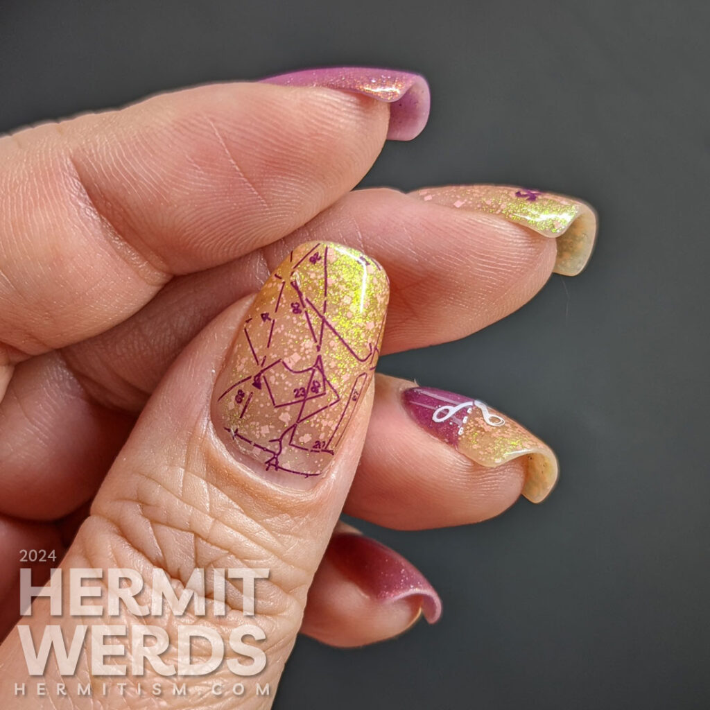 A shimmery orchid and ogup sewing nail art with nail stamping about the forbidden fabric scissors and cutting patterns from fabric.