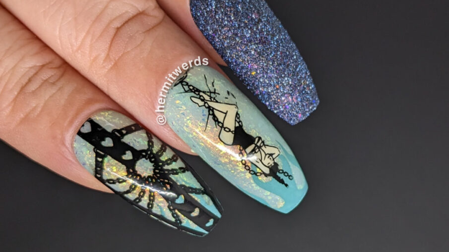 Sexy bondage nail art with stamping images of a heart and chains harness and a lady wrapped in chains on a shimmery aqua polish.