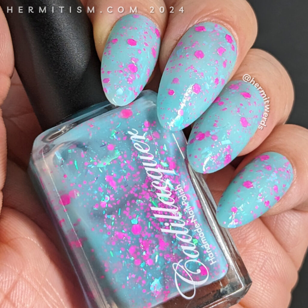A gorgeous milky aqua polish with hot pink hex glitter and flakes covered in swirls of love potion and potion bottle for Valentine's Day.