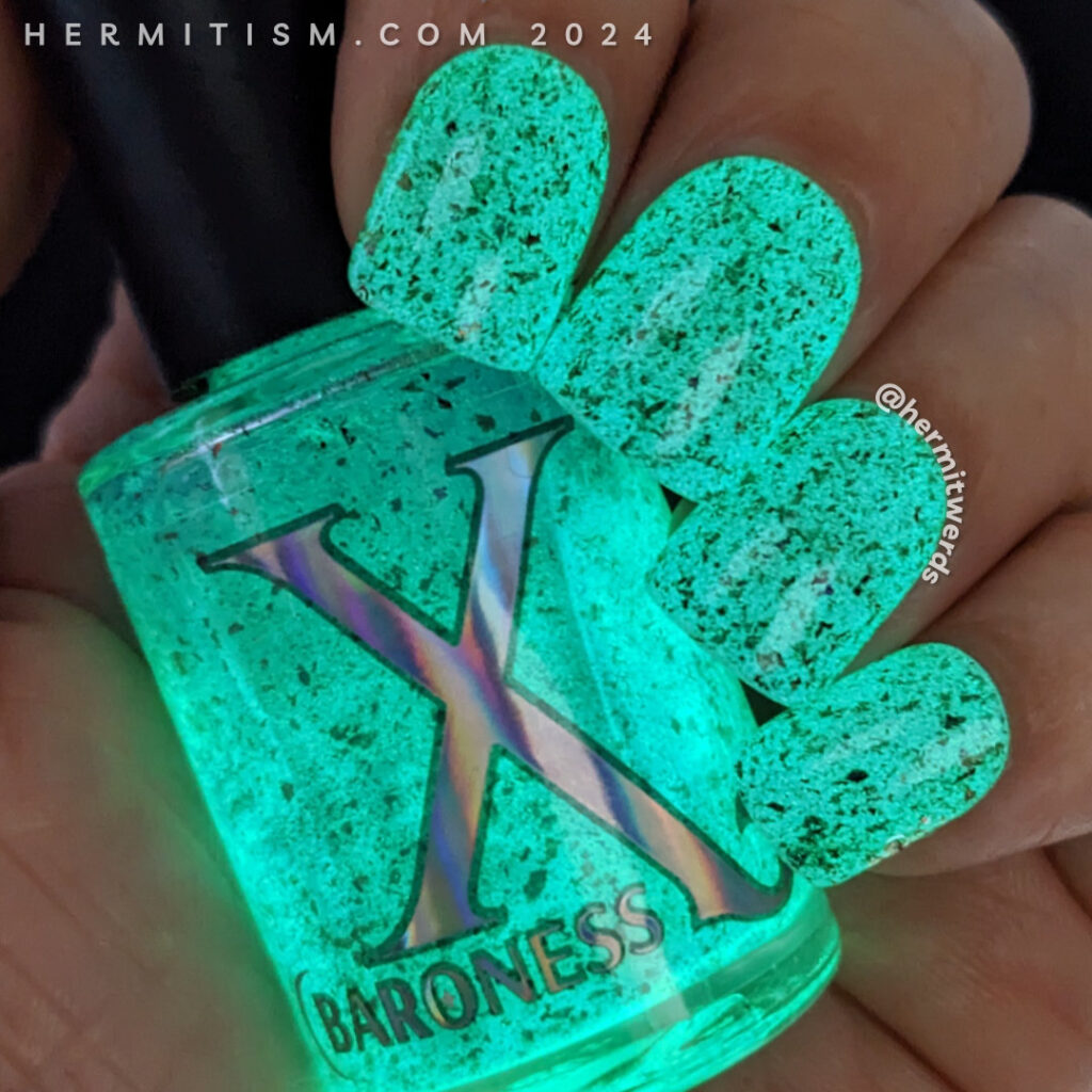 Nail swatch of Baroness X's "Bespoke" in its green glow in the dark state.