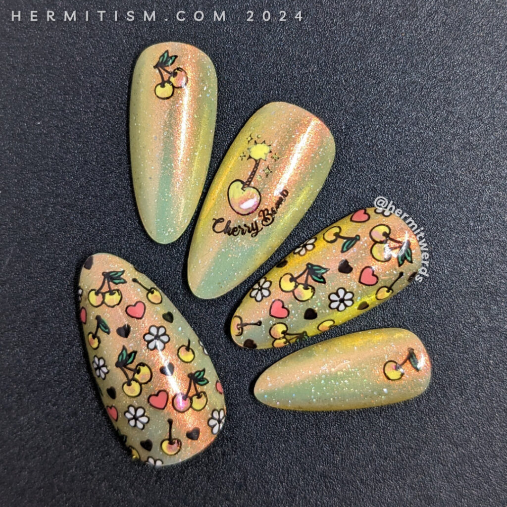 Yellow cherry nail art on a sunny yellow super shifty polish with reverse stamping of a cherry "bomb", yellow cherries, hearts, and flowers.