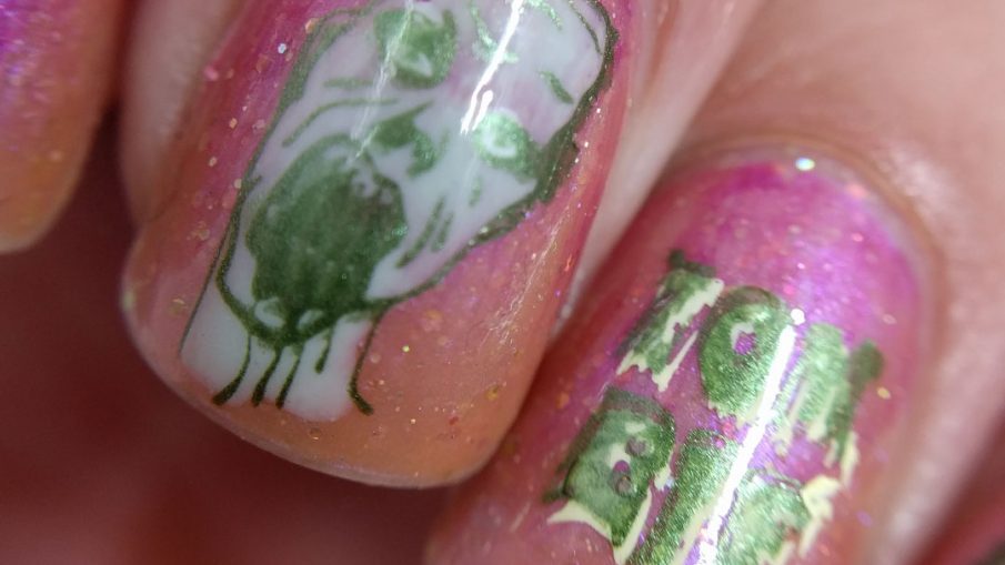 A delicately gruesome zombie nail art using a translucent shimmery orange polish and soft metallic green zombies.