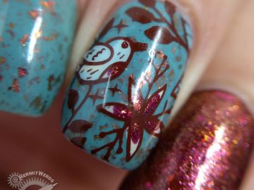 Autumnal nail art with a little blue bird against a robin blue crelly full of pink/orange/red flakies.