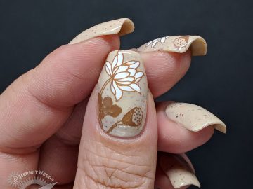 A soft crelly nail art in neutral shades with floral lily pad stamping.