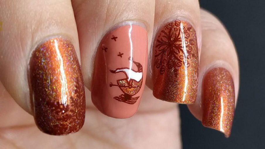 Adorable skiing Santa nail art with an orange holographic color scheme and snow flake stamps.