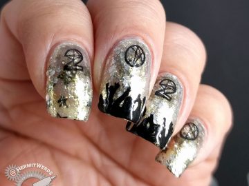 Glittery silver and gold nail art with people cheering and partying underneath a 2020 stamping image.