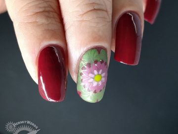A deep red (merlot) nail art with a few brightly colored mandala decals.