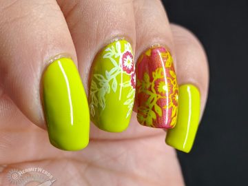Bright green nail art with floral nail stamping in pink and white.